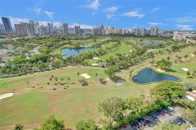 bird's eye view featuring a water view, view of golf course, and a view of city