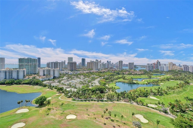 drone / aerial view featuring a view of city, a water view, and golf course view