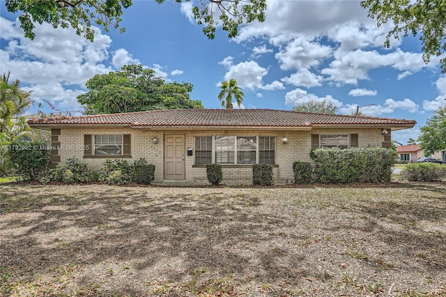 4109 NW 79th Ave, Coral Springs, FL 33065 - ranch-style home with a tiled roof and brick siding