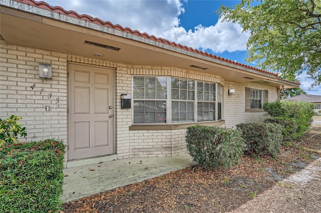 4109 NW 79th Ave, Coral Springs, FL 33065 - doorway to property featuring a tiled roof and brick siding