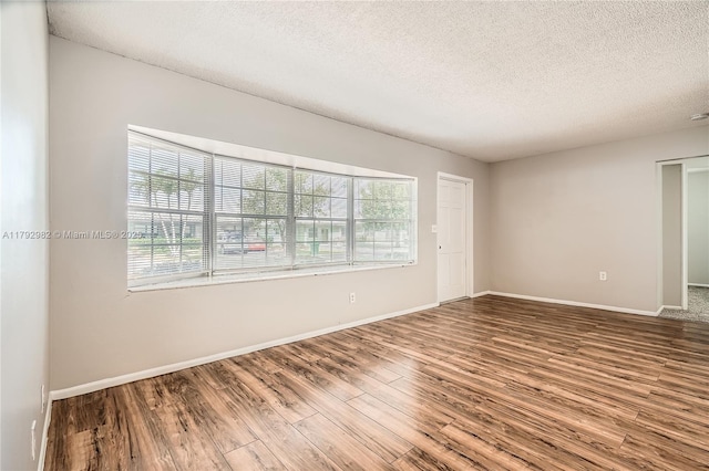 4109 NW 79th Ave, Coral Springs, FL 33065 - spare room with a textured ceiling, baseboards, and wood finished floors