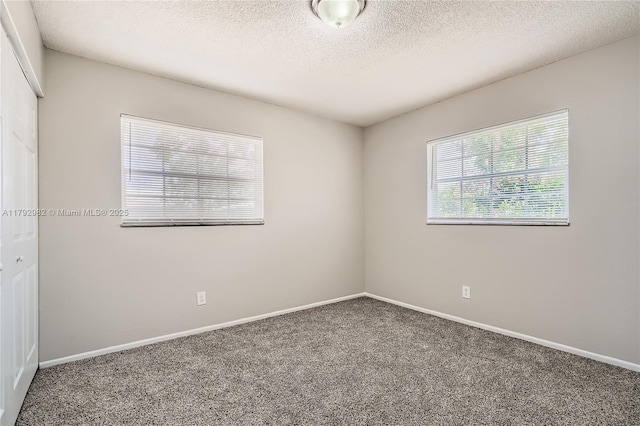 4109 NW 79th Ave, Coral Springs, FL 33065 - spare room featuring baseboards, carpet flooring, and a textured ceiling