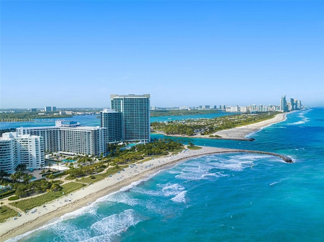 birds eye view of property featuring a water view, a view of the beach, and a view of city