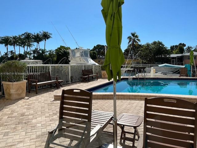 2020 NE 135th St Unit 609, North Miami, FL 33181 - community pool featuring a patio area and fence