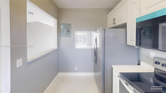 9900 Sunrise Lakes Blvd Unit 309, Sunrise, FL 33322 - kitchen featuring stainless steel electric range oven, baseboards, white cabinets, electric panel, and light marble finish floors