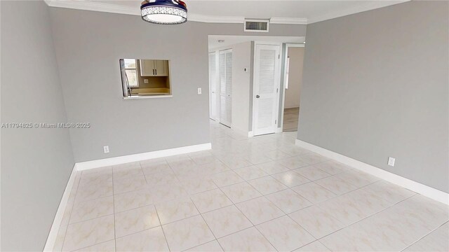 9900 Sunrise Lakes Blvd Unit 309, Sunrise, FL 33322 - spare room with baseboards, ornamental molding, light tile patterned floors, and visible vents