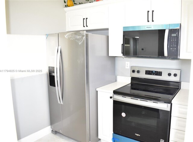 9900 Sunrise Lakes Blvd Unit 309, Sunrise, FL 33322 - kitchen featuring light countertops, appliances with stainless steel finishes, and white cabinetry