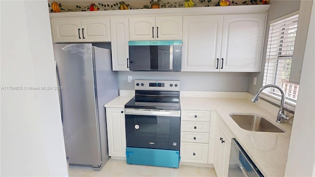 9900 Sunrise Lakes Blvd Unit 309, Sunrise, FL 33322 - kitchen with stainless steel appliances, a sink, white cabinetry, and light stone counters