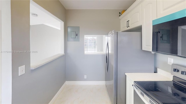 9900 Sunrise Lakes Blvd Unit 309, Sunrise, FL 33322 - kitchen with stainless steel electric stove, white cabinets, baseboards, electric panel, and light countertops