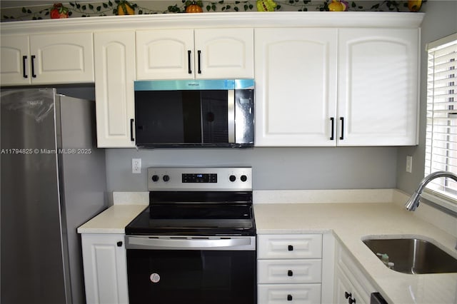 9900 Sunrise Lakes Blvd Unit 309, Sunrise, FL 33322 - kitchen with white cabinetry, light stone countertops, appliances with stainless steel finishes, and a sink