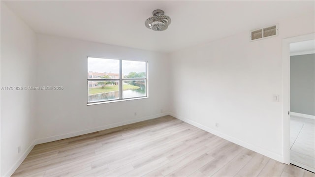 9900 Sunrise Lakes Blvd Unit 309, Sunrise, FL 33322 - empty room with light wood finished floors, baseboards, and a water view