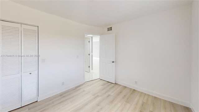 9900 Sunrise Lakes Blvd Unit 309, Sunrise, FL 33322 - unfurnished bedroom featuring light wood-style flooring, baseboards, and a closet