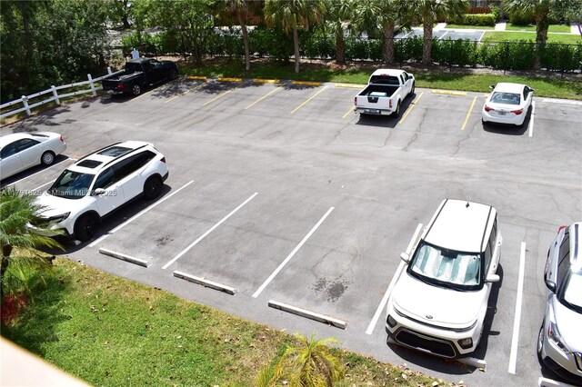 9900 Sunrise Lakes Blvd Unit 309, Sunrise, FL 33322 - uncovered parking lot featuring fence