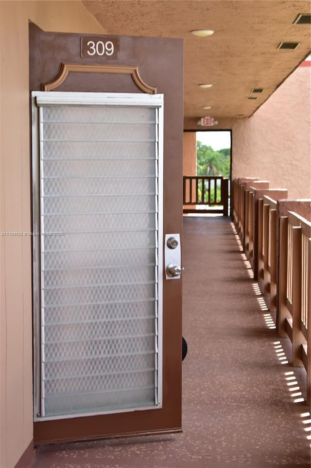 9900 Sunrise Lakes Blvd Unit 309, Sunrise, FL 33322 - doorway to property with visible vents, stucco siding, and a balcony