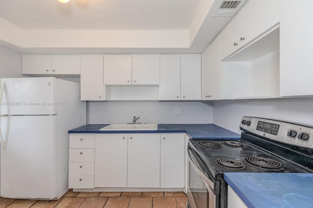 3710 Harrison St Unit 1, Hollywood, FL 33021 - kitchen with visible vents, freestanding refrigerator, stainless steel electric stove, white cabinets, and a sink