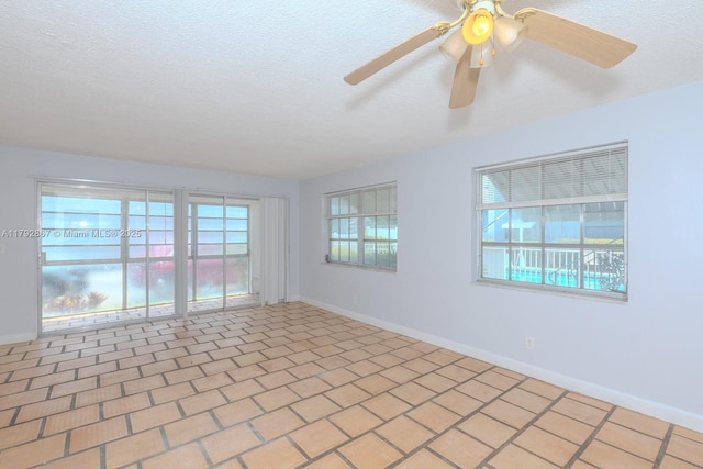 3710 Harrison St Unit 1, Hollywood, FL 33021 - empty room with plenty of natural light, a ceiling fan, baseboards, and a textured ceiling