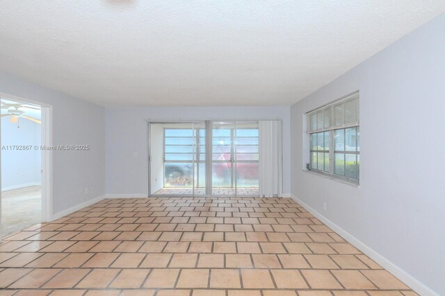 3710 Harrison St Unit 1, Hollywood, FL 33021 - spare room with baseboards, a textured ceiling, and ceiling fan