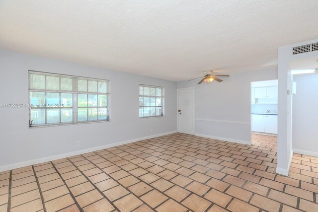 3710 Harrison St Unit 1, Hollywood, FL 33021 - unfurnished room featuring baseboards, a ceiling fan, a textured ceiling, and visible vents
