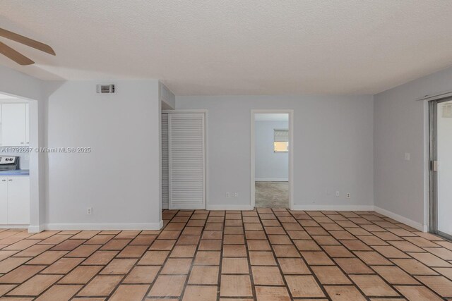 3710 Harrison St Unit 1, Hollywood, FL 33021 - spare room featuring a ceiling fan, a textured ceiling, visible vents, and baseboards
