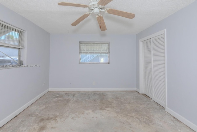 3710 Harrison St Unit 1, Hollywood, FL 33021 - unfurnished bedroom with a closet, baseboards, multiple windows, and unfinished concrete floors