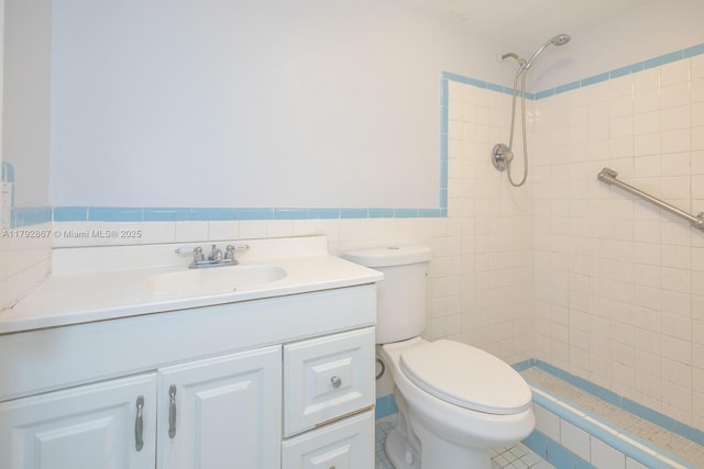 3710 Harrison St Unit 1, Hollywood, FL 33021 - bathroom featuring vanity, toilet, a wainscoted wall, tile walls, and tiled shower