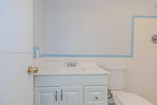 3710 Harrison St Unit 1, Hollywood, FL 33021 - bathroom featuring vanity, wainscoting, toilet, and tile walls