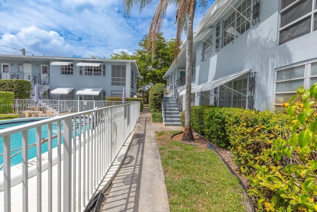 3710 Harrison St Unit 1, Hollywood, FL 33021 - surrounding community with stairs, fence, and a pool