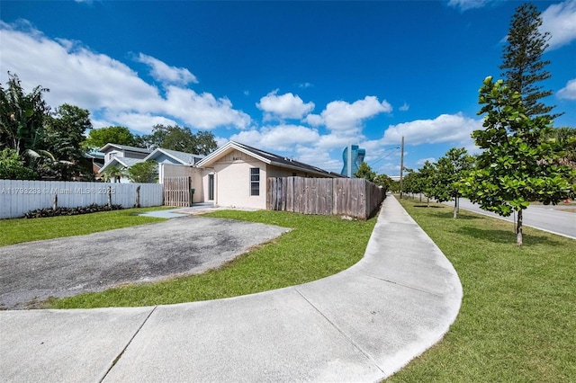 5411 SW 43rd Ter, Dania Beach, FL 33314 - exterior space featuring a lawn, a gate, a fenced front yard, and stucco siding