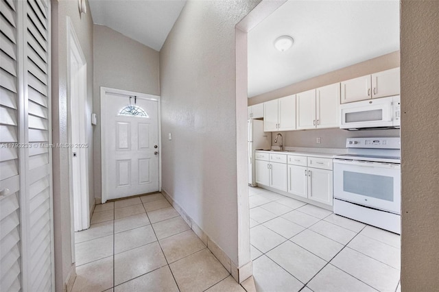 5411 SW 43rd Ter, Dania Beach, FL 33314 - kitchen with white cabinets, a sink, white appliances, light countertops, and light tile patterned floors