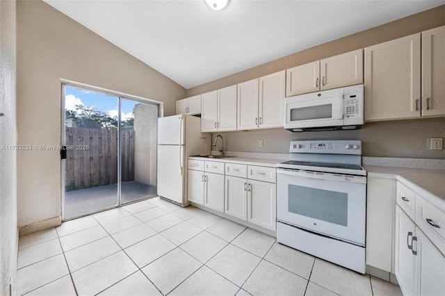 5411 SW 43rd Ter, Dania Beach, FL 33314 - kitchen featuring lofted ceiling, white appliances, light countertops, white cabinetry, and a sink