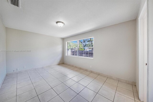 5411 SW 43rd Ter, Dania Beach, FL 33314 - empty room with a textured ceiling, visible vents, and light tile patterned floors