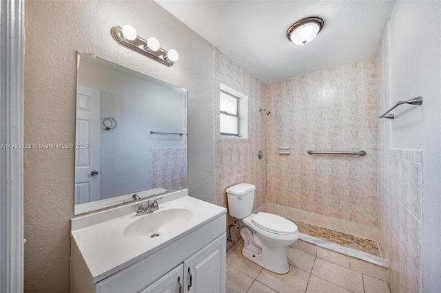 5411 SW 43rd Ter, Dania Beach, FL 33314 - full bath featuring a textured wall, tile patterned flooring, vanity, toilet, and tiled shower