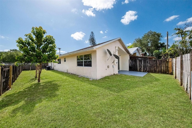 5411 SW 43rd Ter, Dania Beach, FL 33314 - rear view of house featuring a fenced backyard, stucco siding, a yard, and a patio area