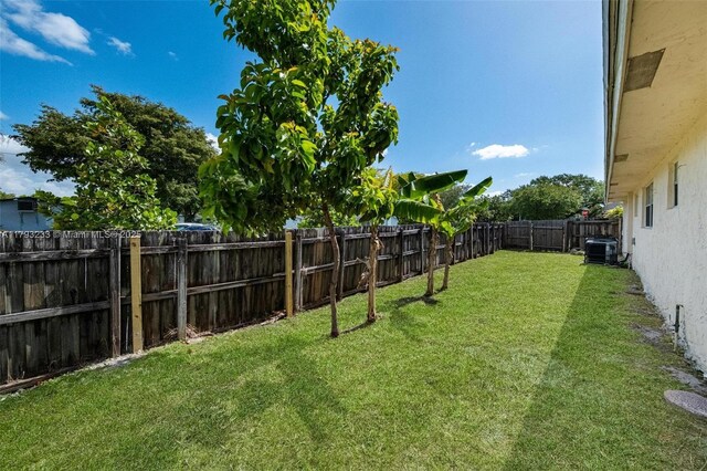 5411 SW 43rd Ter, Dania Beach, FL 33314 - view of yard with a fenced backyard and central AC