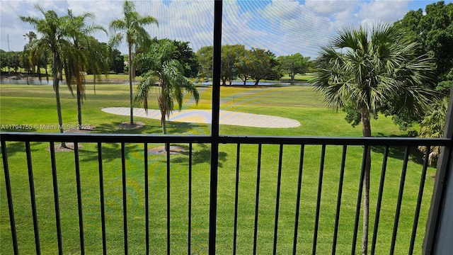 surrounding community with a lawn, view of golf course, and a water view