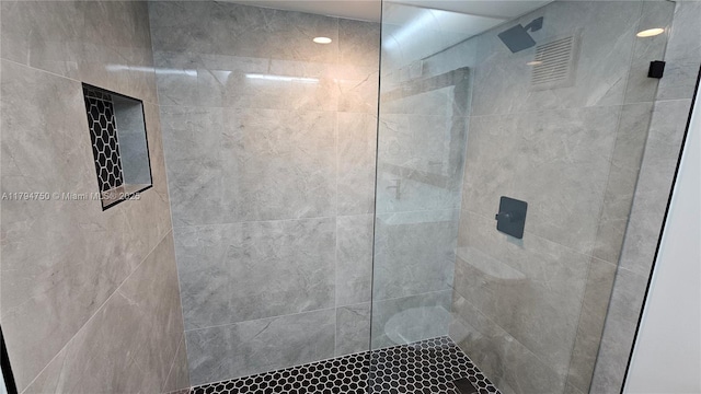 bathroom with tiled shower