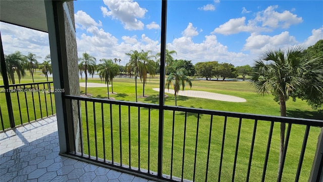 view of property's community with a yard, a water view, and golf course view