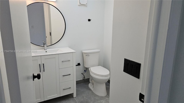 bathroom featuring vanity, tile patterned flooring, and toilet
