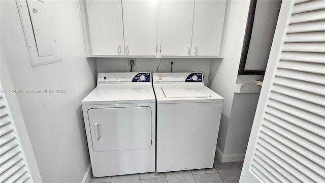 washroom with baseboards, cabinet space, light tile patterned floors, and washer and dryer