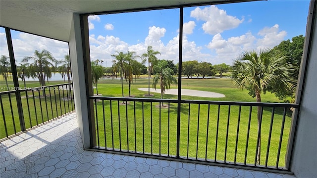 unfurnished sunroom featuring a water view and golf course view