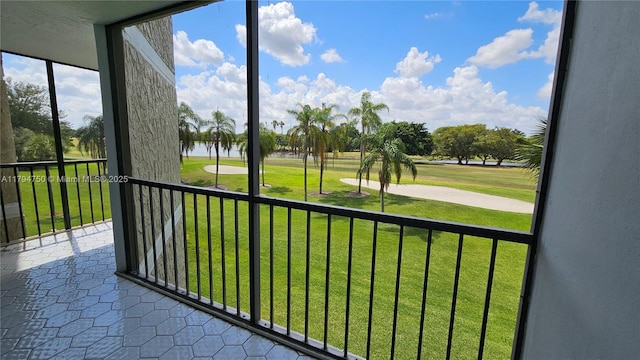 unfurnished sunroom with a water view and view of golf course