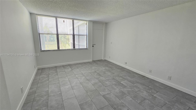 spare room featuring a textured ceiling