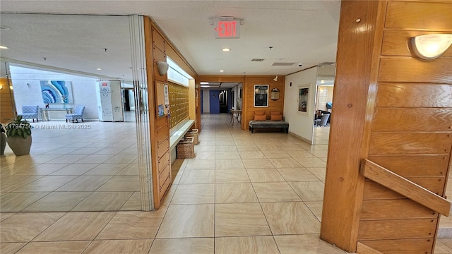 hall featuring light tile patterned floors