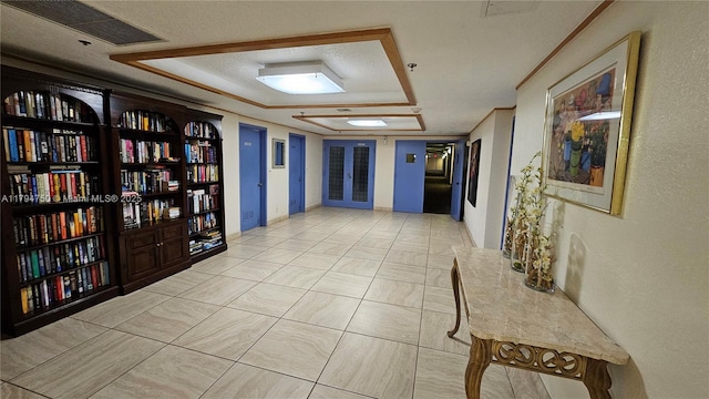 corridor featuring visible vents and a raised ceiling