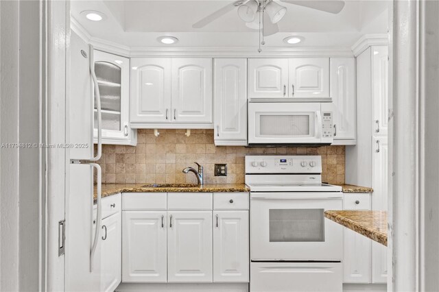 kitchen with a sink, a ceiling fan, white appliances, and white cabinetry