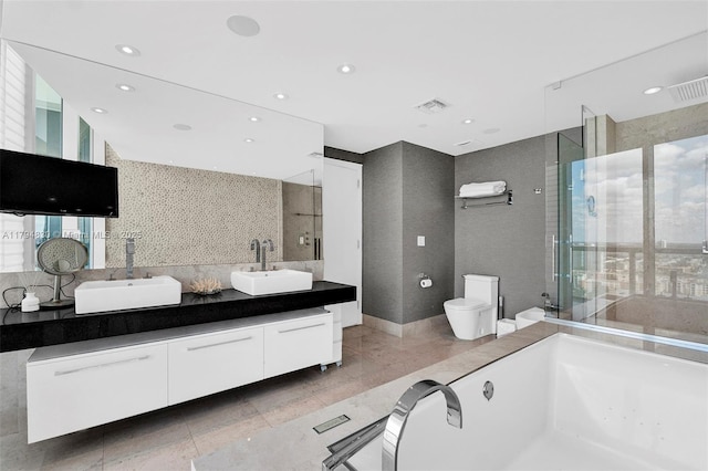 17121 Collins Ave Unit 2608, Sunny Isles Beach, FL 33160 - full bathroom with visible vents, double vanity, toilet, a bath, and a sink