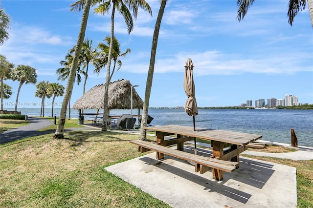 view of property's community with a lawn, a gazebo, and a water view