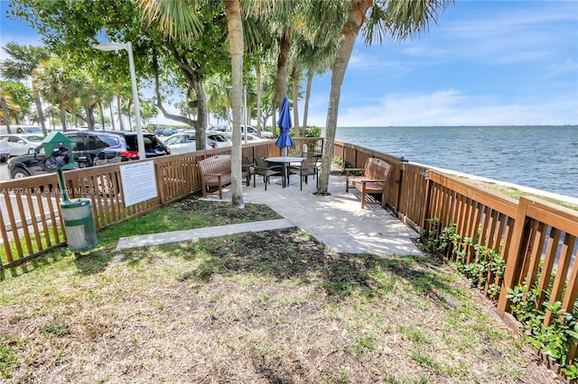 view of yard with fence and a water view
