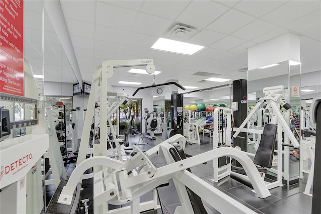 workout area featuring visible vents and a paneled ceiling