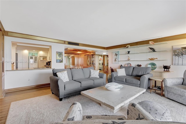 living area with light wood-style flooring and visible vents